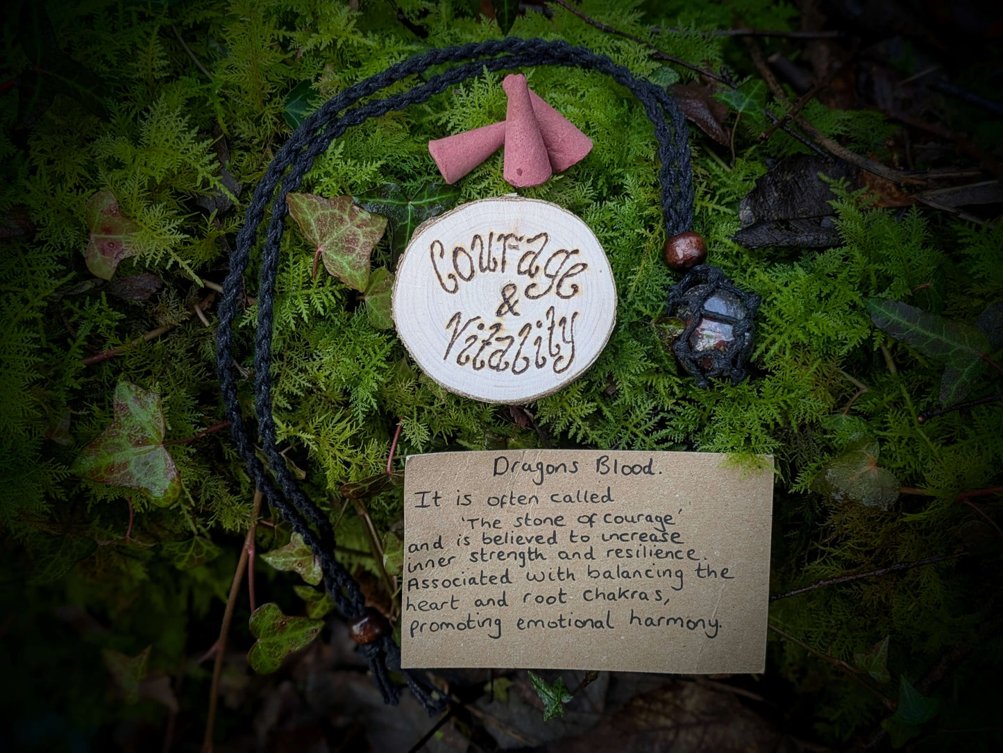 A spiritual wellness item featuring Dragon’s Blood-themed grounding set with crystal-inspired imagery, incense, and ritual accessories in a warm, earthy aesthetic.