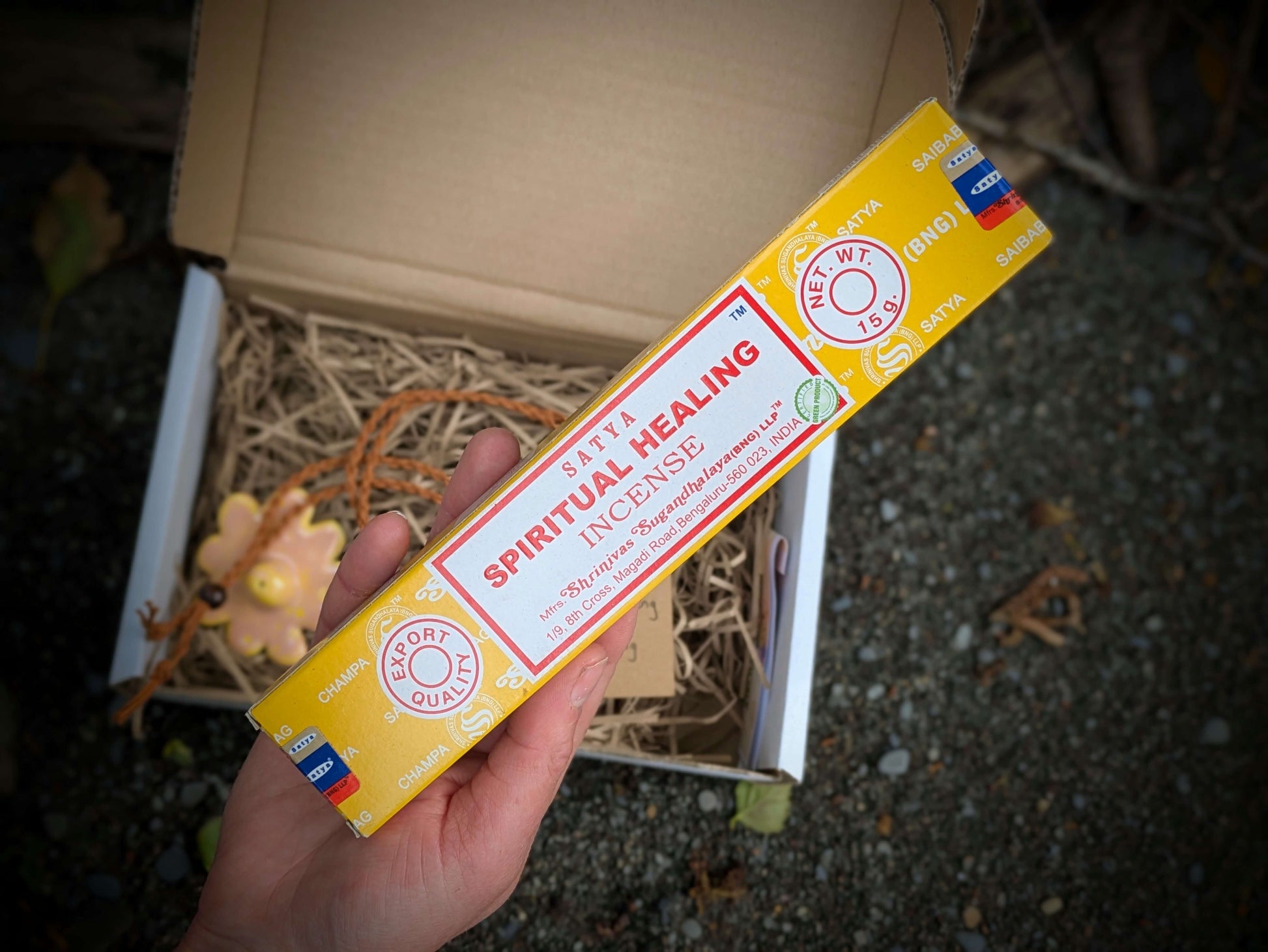 Box of 'Spiritual Healing' incense held by a hand with a blurred background