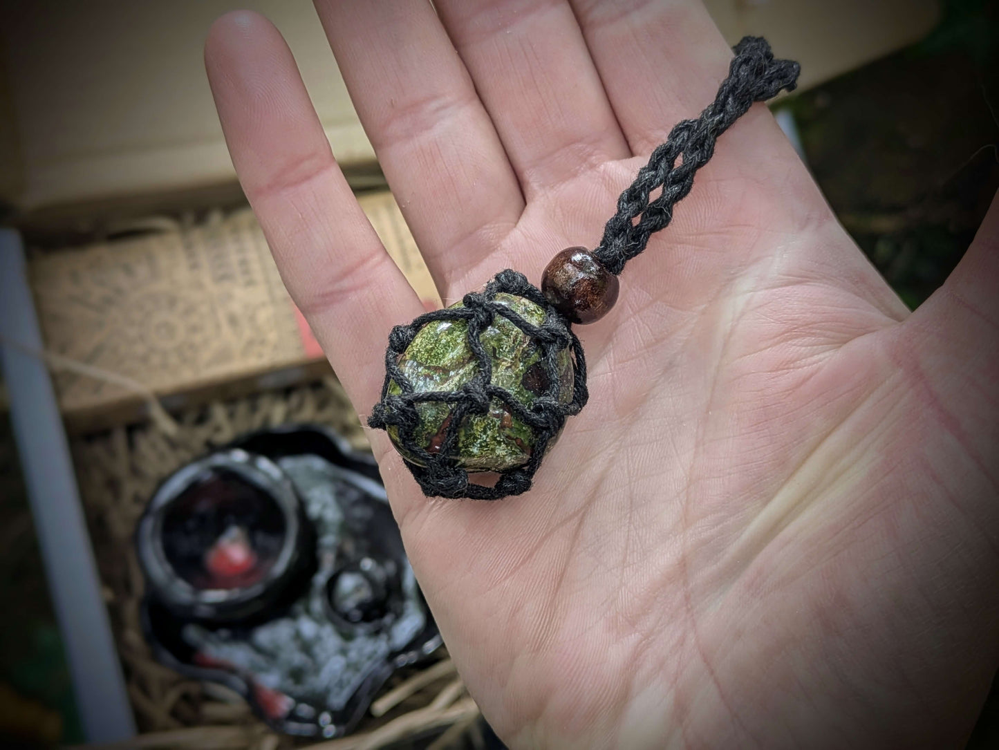 A spiritual wellness item featuring Dragon’s Blood-themed grounding set with crystal-inspired imagery, incense, and ritual accessories in a warm, earthy aesthetic.